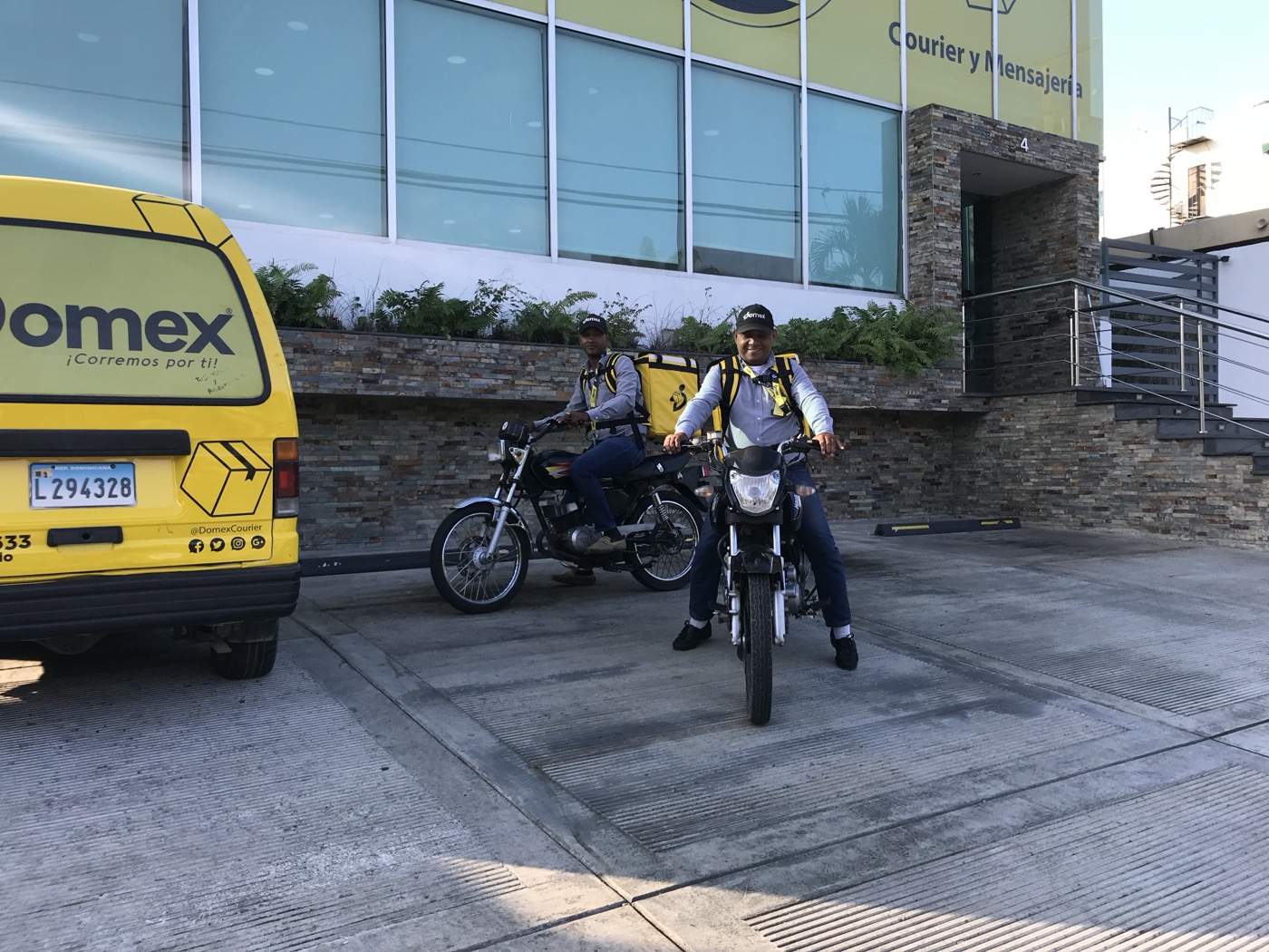 Unidad de reparto y motocicletas de Domex saliendo a ruta